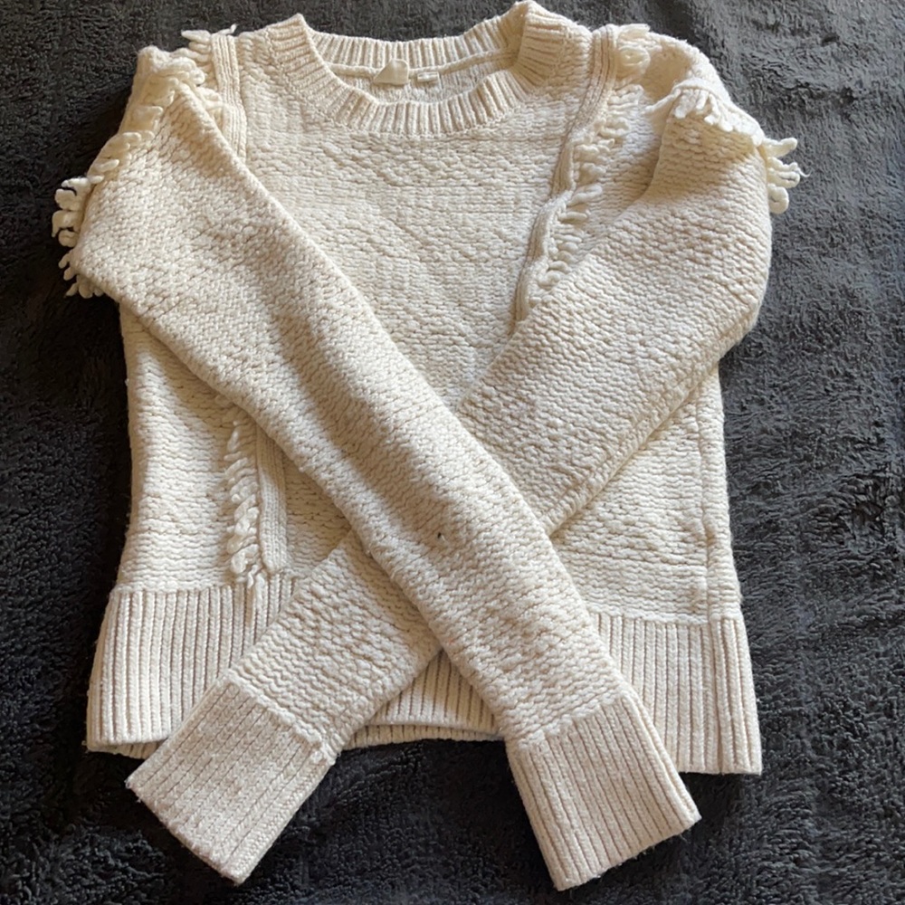 Chunky white knit sweater with frayed shoulders